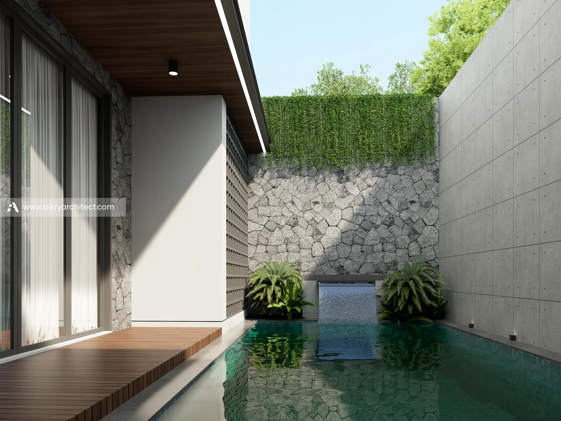 Kolam renang dengan dinding batu alam, pancuran air, dan dek kayu di sisi dalam rumah